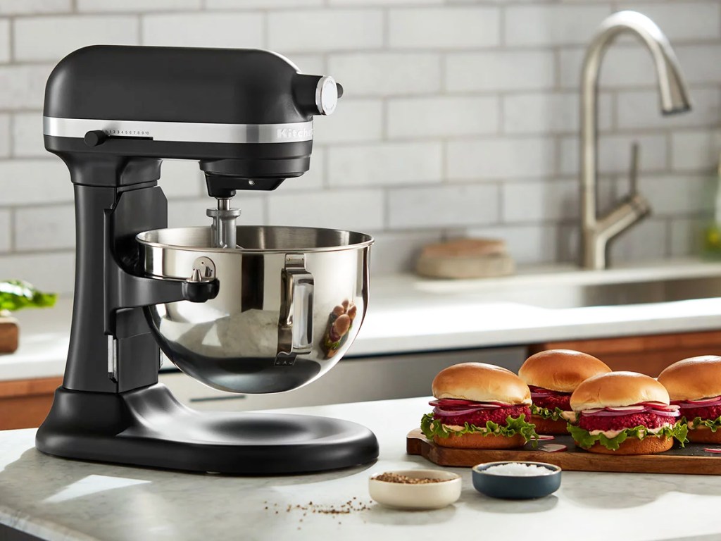 black kitchenaid mixer on counter next to plate of burgers