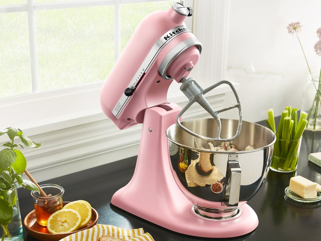 pink kitchenaid mixer on counter with ingredients around it