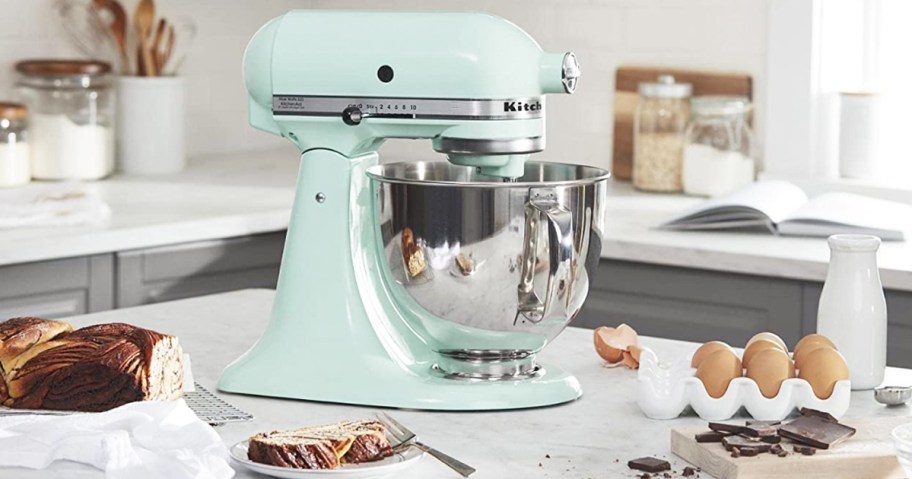 light blue kitchenaid mixer on counter with baking ingredients around it