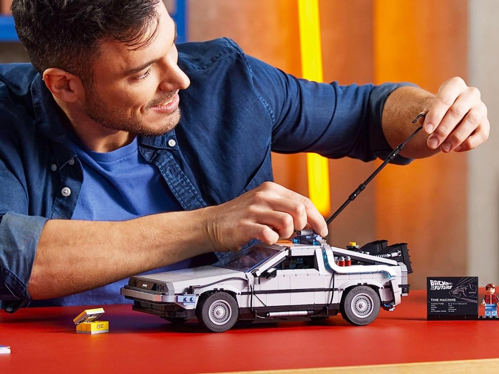 man playing with LEGO Icons Back to The Future Time Machine
