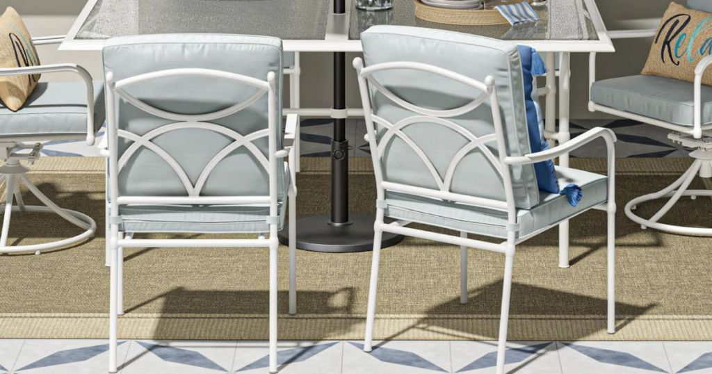back view of 2 patio dining chairs in front of a dining table