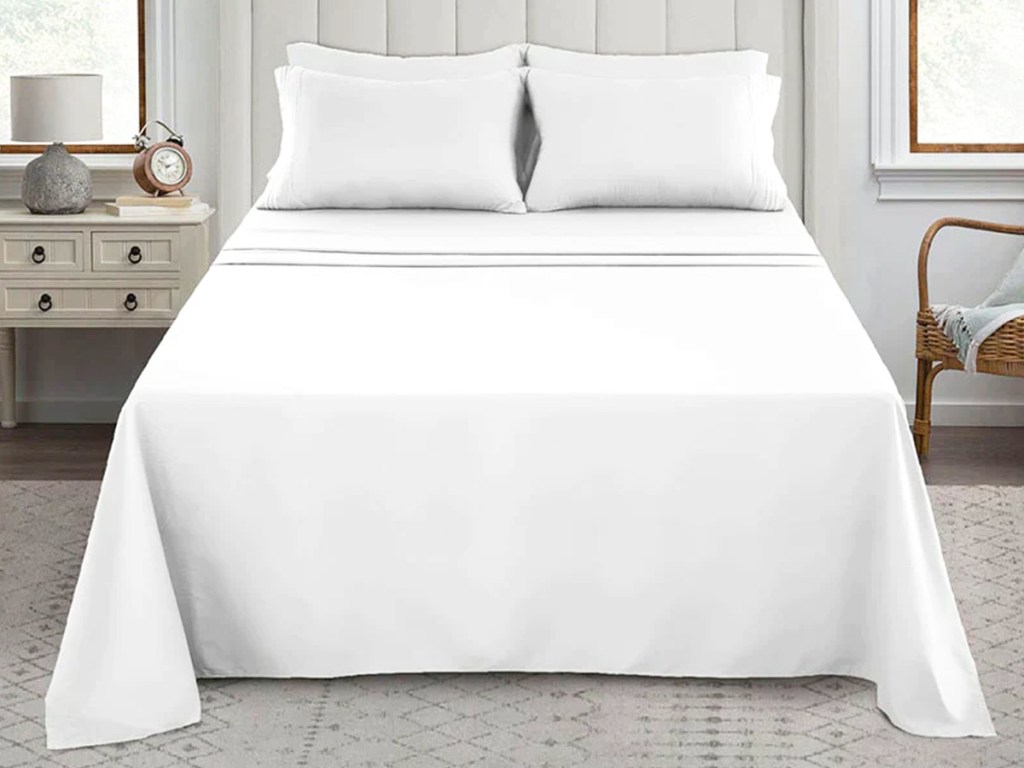 white sheets and pillowcases on bed