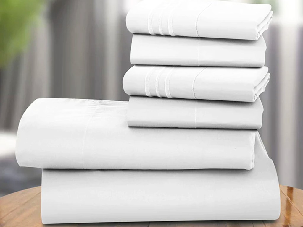 stack of folded white sheets and pillowcases