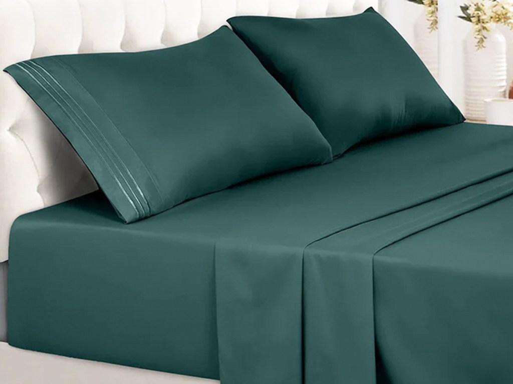 green sheets and pillow cases on a bed