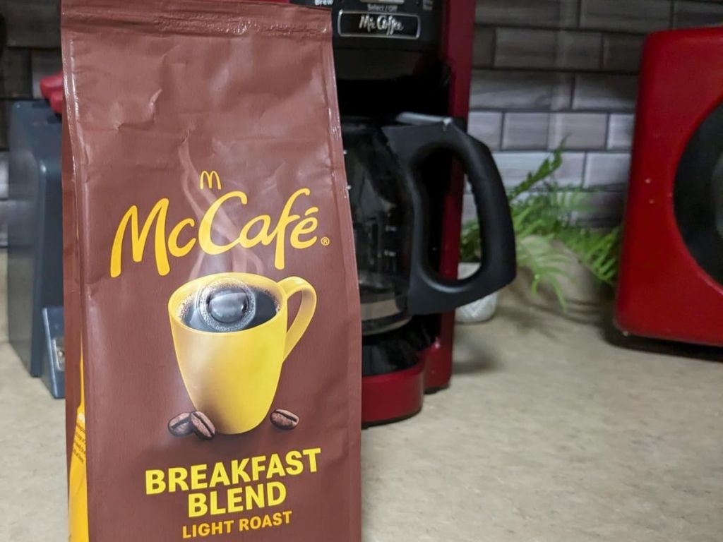 Coffee pot with a bag of McCafe Coffee in front of it