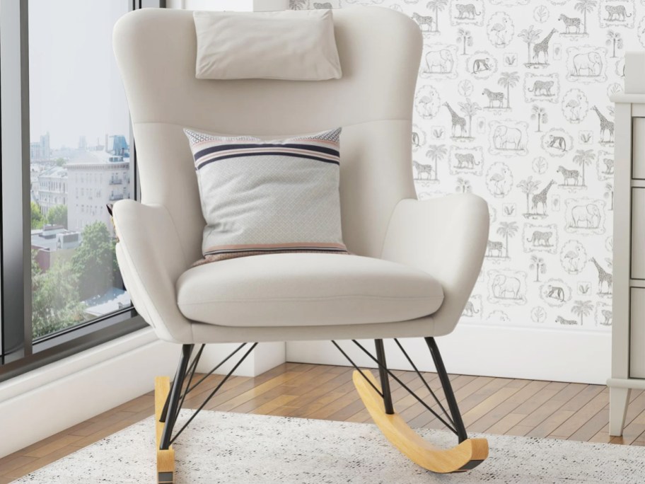 white upholstered rocking chair with wooden legs