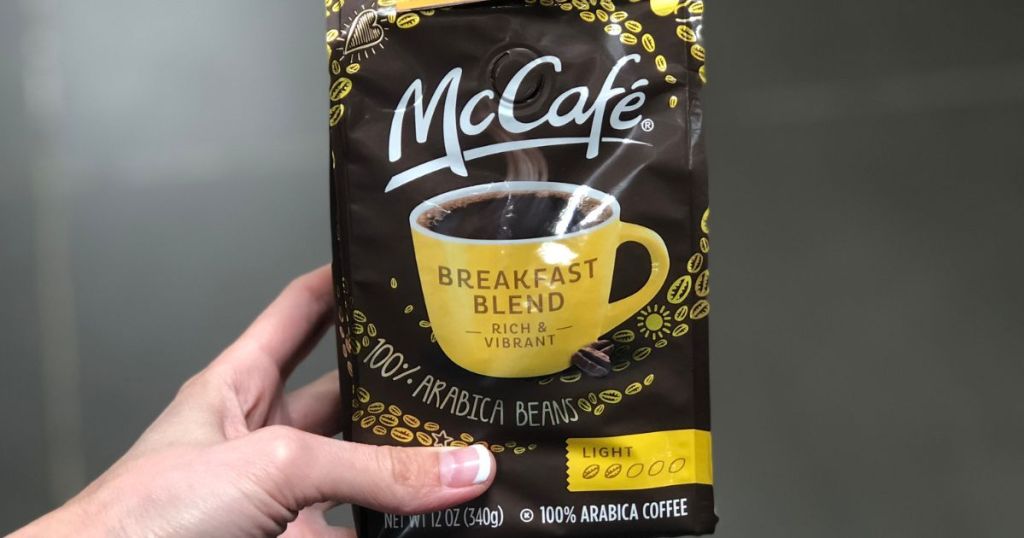 A Hand holding a bag of McCafe Coffee
