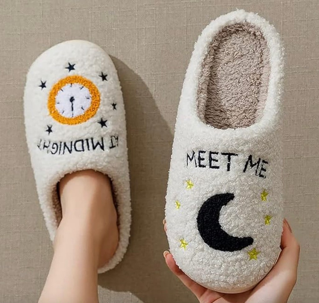 hand holding meet me at midnight slippers