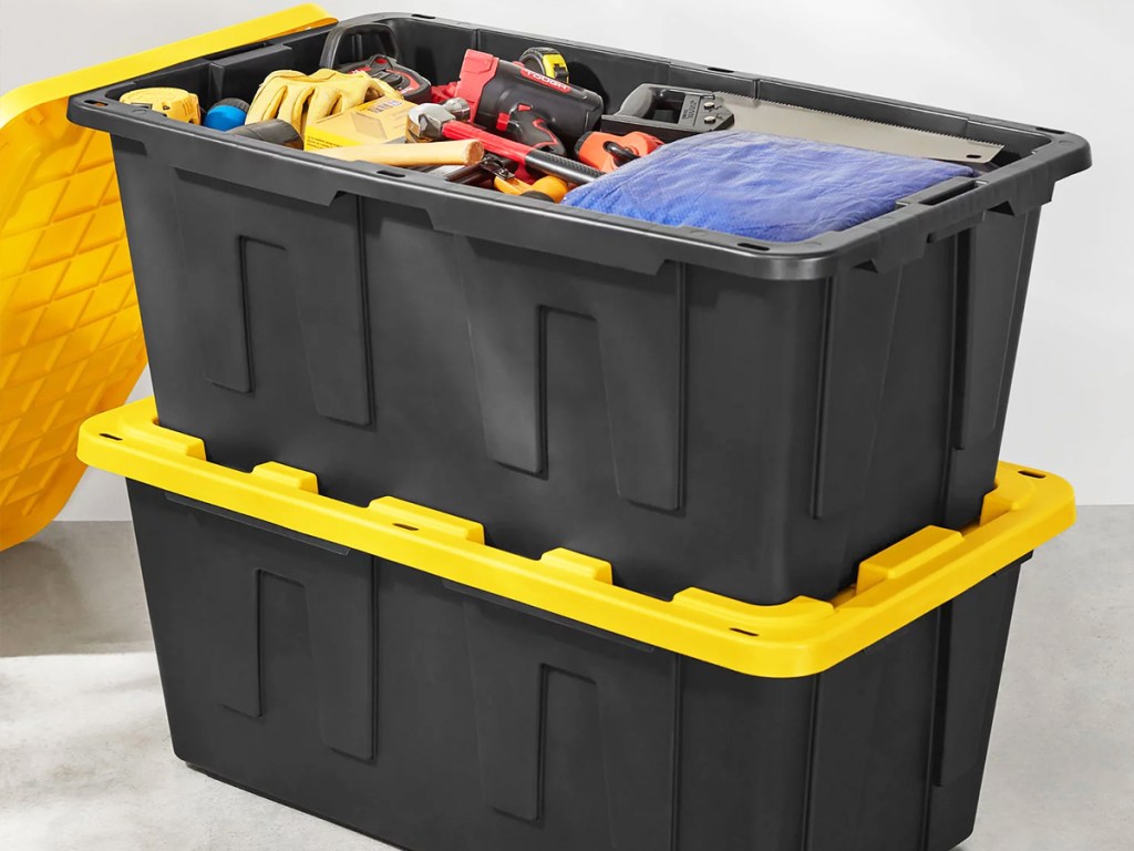 stacked black and yellow storage totes
