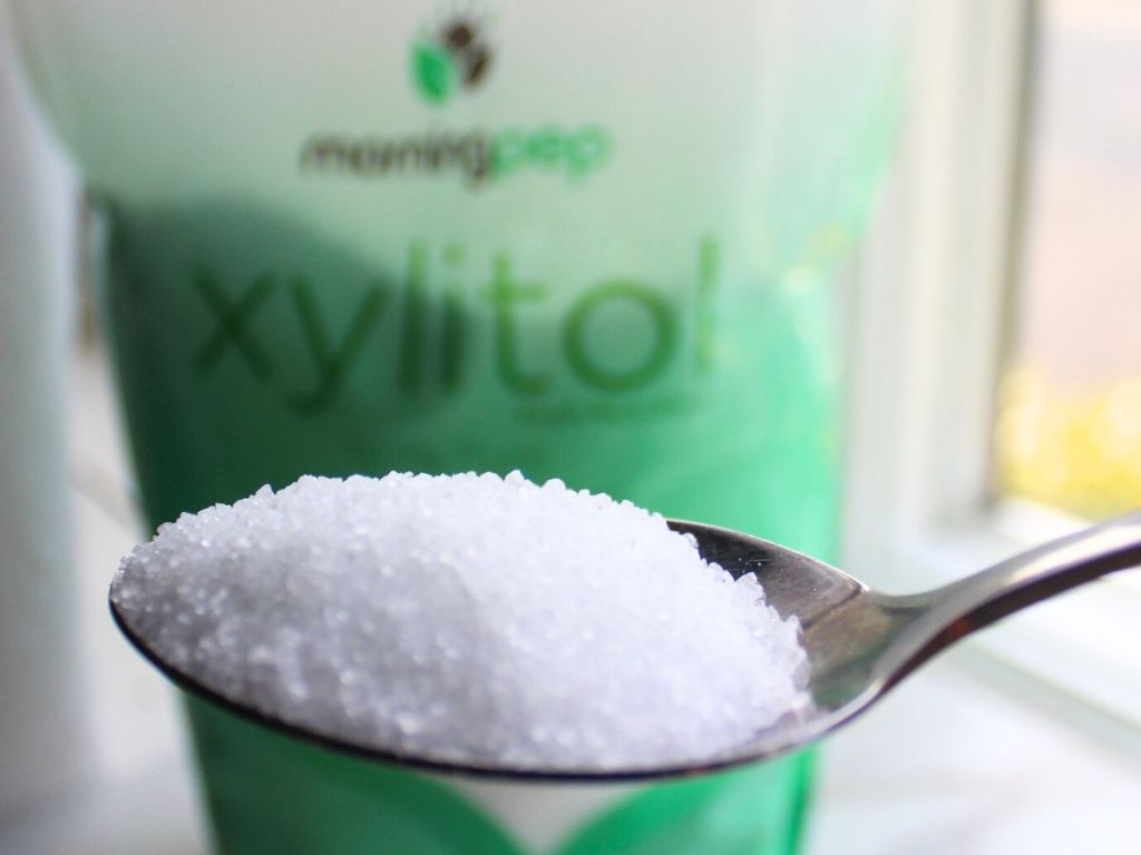 A spoonful of morning pep xylitol in front of the whole bag