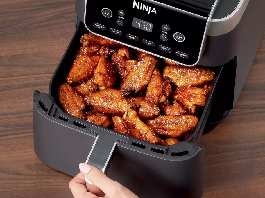ninja air fryer with basket full of chicken wings