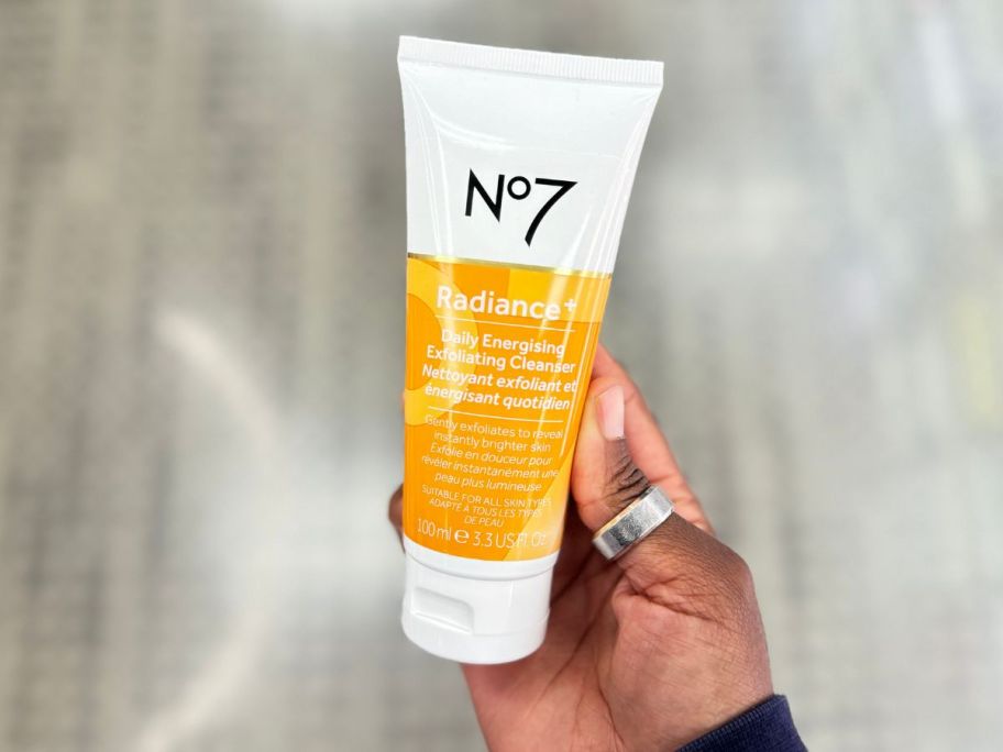 hand holding No7 Radiance+ Daily Energizing Exfoliating Cleanser - 3.38 fl oz in store