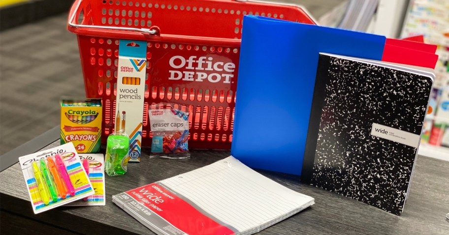 school supplies on table in front of red office depot shopping basket