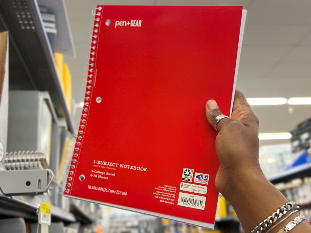 Hand holding up a Pen+Gear Spiral Notebook at Walmart
