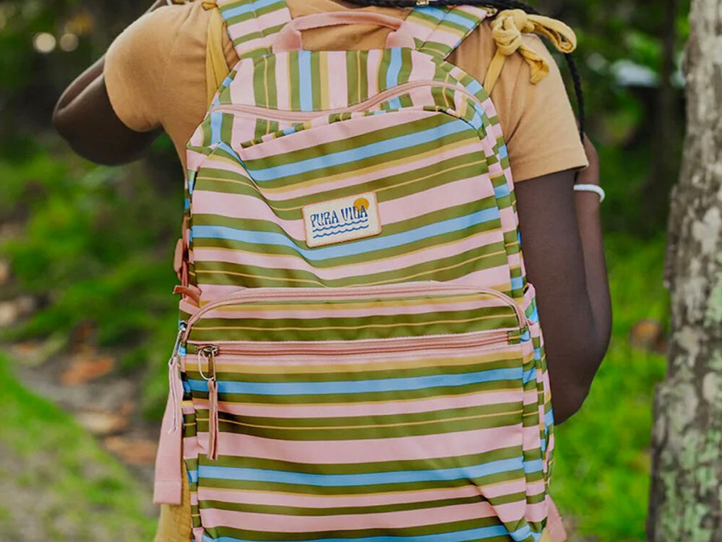 girl wearing a striped backpack