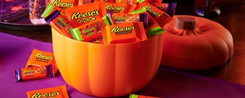 Reese's Pumpkin Bowl w 110 Treats sitting on a table at a halloween party