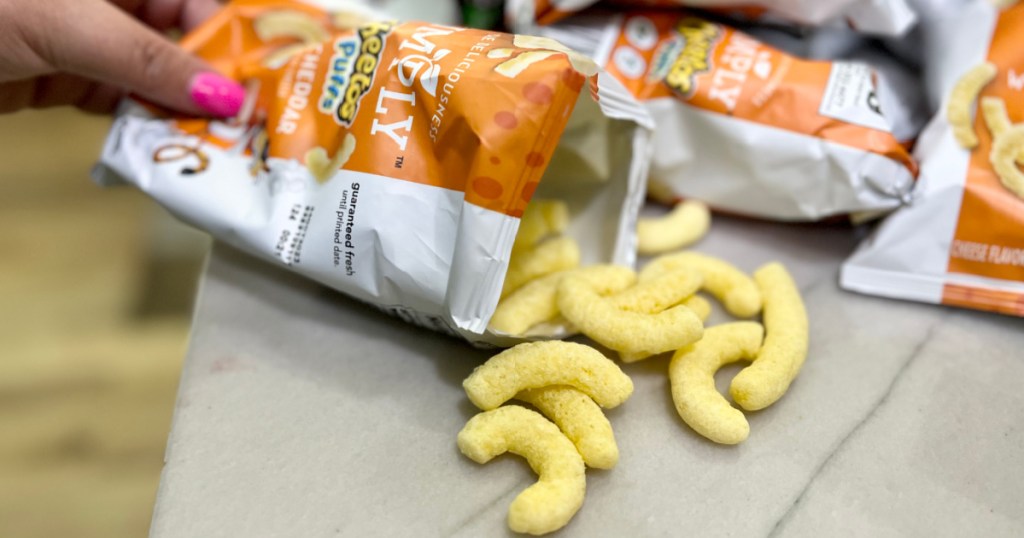 pouring cheetos puffs out from bag