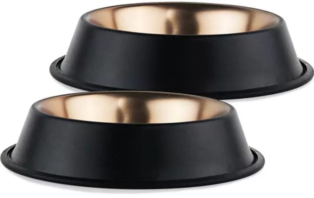 Stock image of two matte black dog bowls with a copper insode