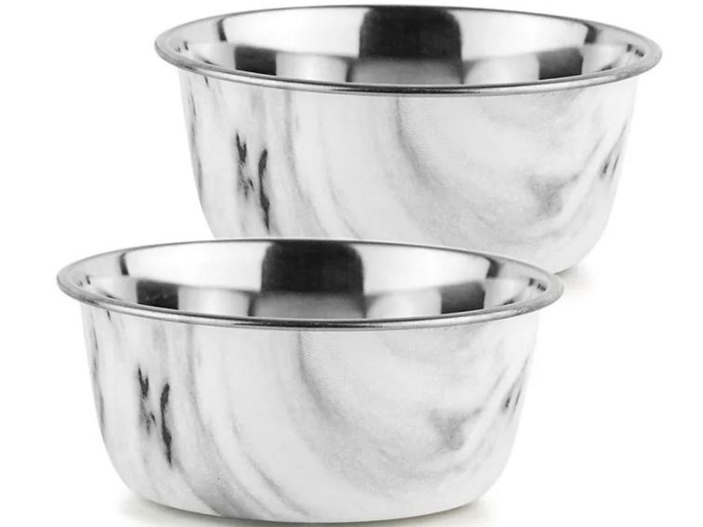 Stock image of two white marble steel dog bowls