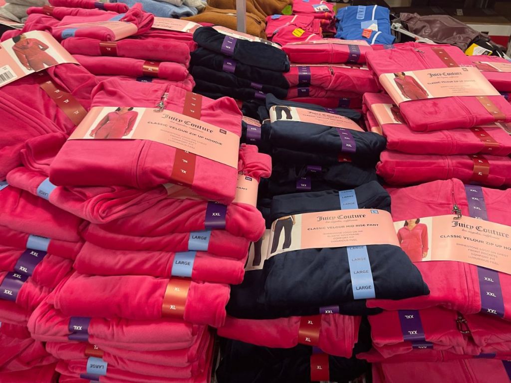 A pile of Juicy Couture Tracksuits on clearance at Sam's Club