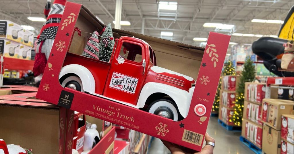 Hand holding up a Sam's Club Vintage Holiday Truck