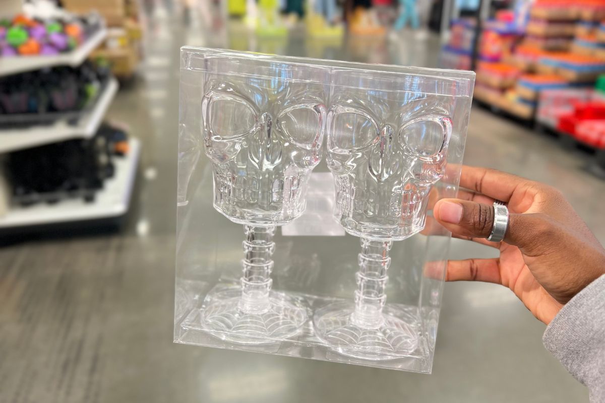 a womans hand holding up a box of Skull goblets