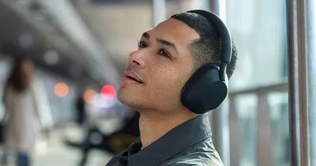 Sony Wireless Bluetooth Noise Canceling Headphones being worn by a guy in an airport