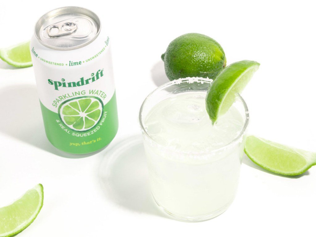 spindrift can next to glass of sparkling water with limes