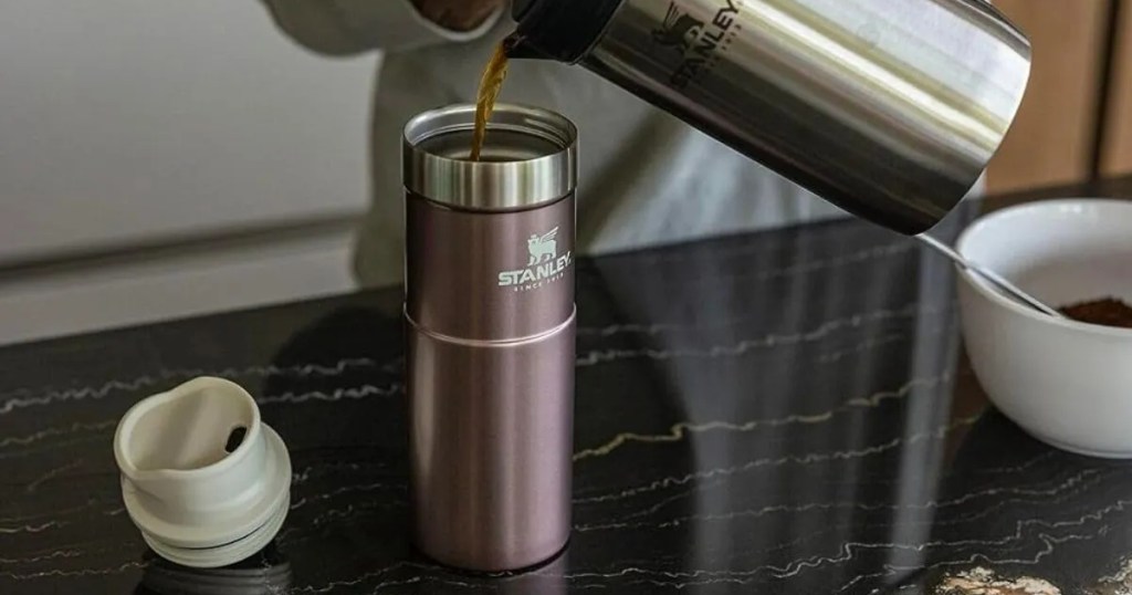 pouring coffee into a travel mug