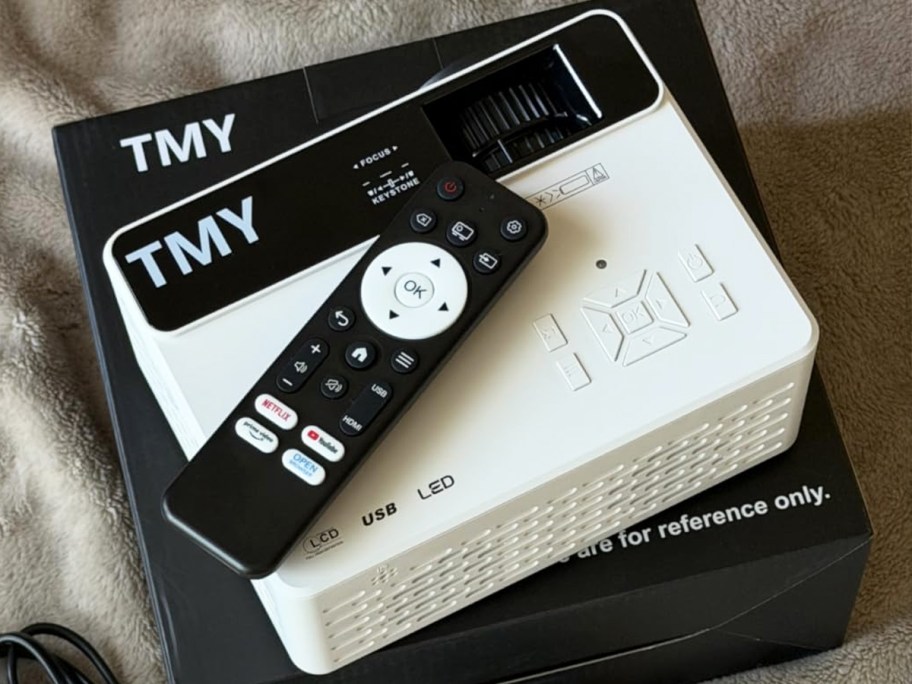 remote on top of a white mini projector