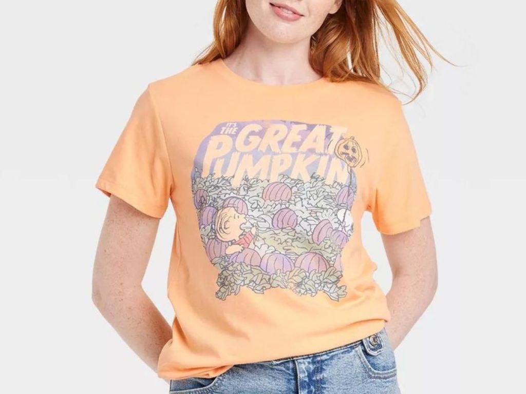 Woman wearing a The Great Pumpkin Graphic Tee