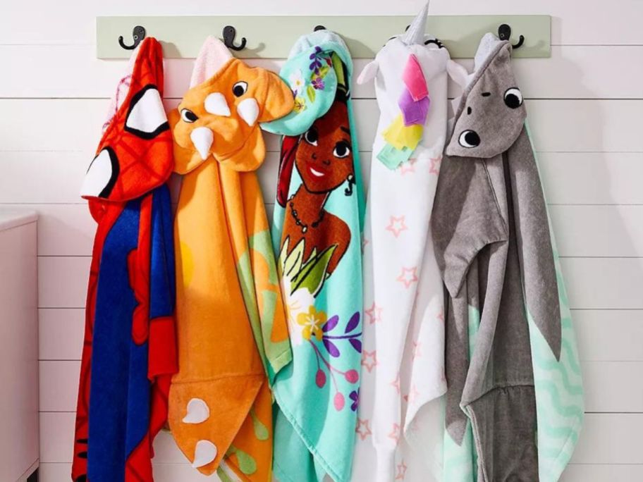 Five different The Big One Hooded Bath Towels hanging up on a rack in a bathrom