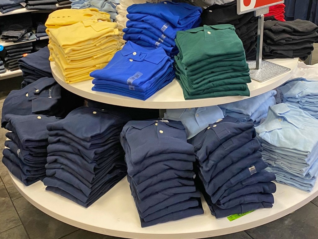 round display table full of folded boys polo shirts
