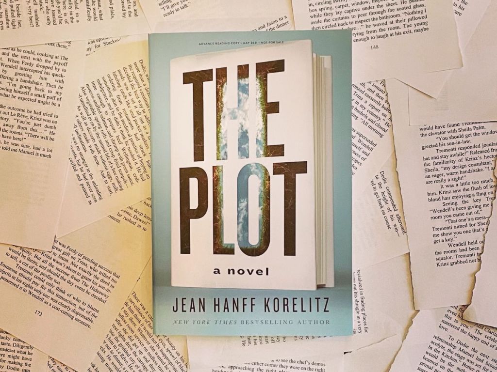 The Plot by Jean Hanff Korelitz sitting on a pile of pages