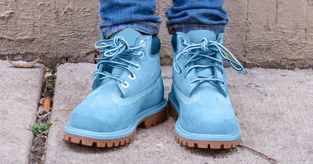 boy wearing a pair of blue timberland boots
