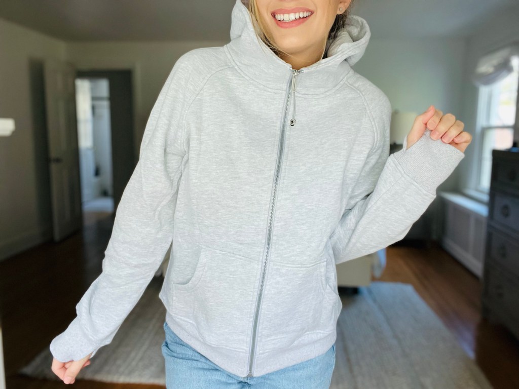 woman posing in light gray full zip up hoodie