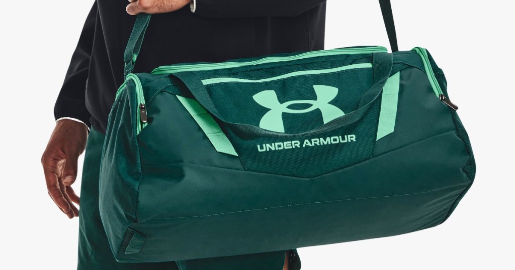 man with green under armour duffle
