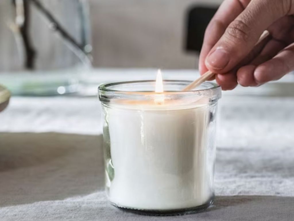 hand lighting an IKEA jar candle