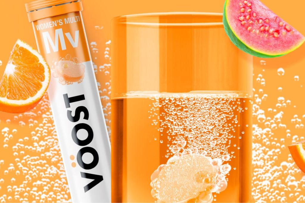 a tubes of Voost water enhancer with a glass containing a tablet 
