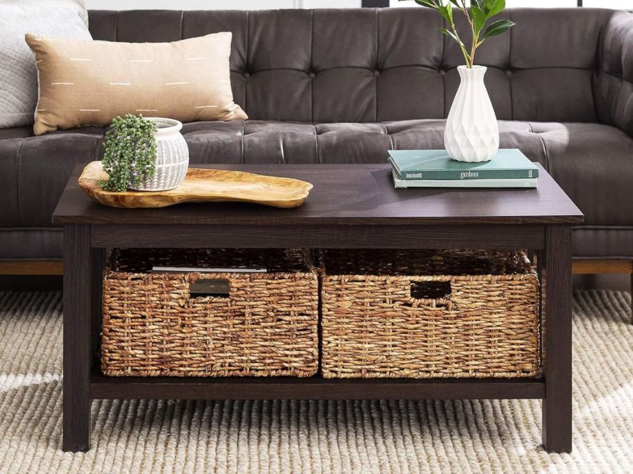 a dark brown coffee table with rattan storage baskets a living room