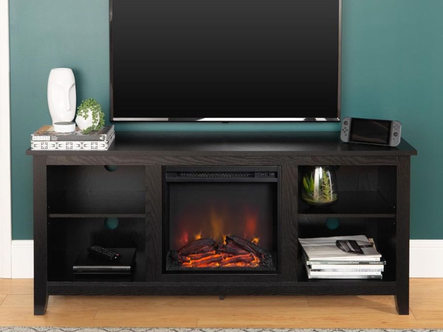 a dark brown Fireplace TV Stand with tv on top