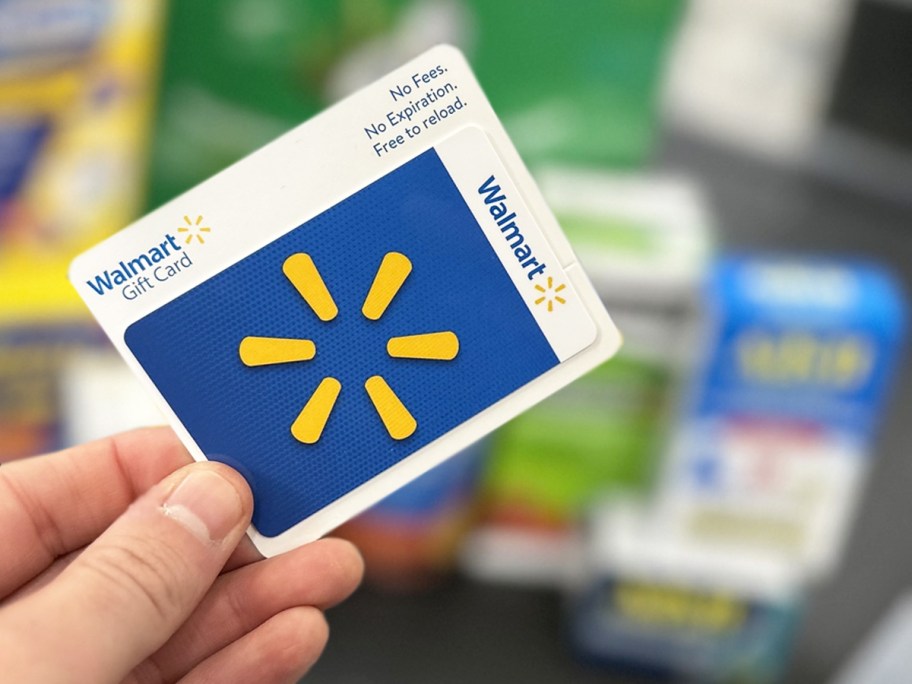 hand holding a walmart gift card