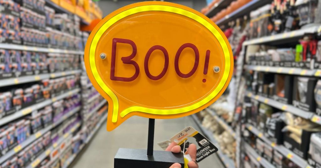 Hand holding up a Light up neon Boo! Light from Walmart