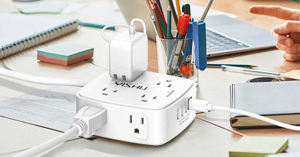 multiple plugs plugged into white square power strip