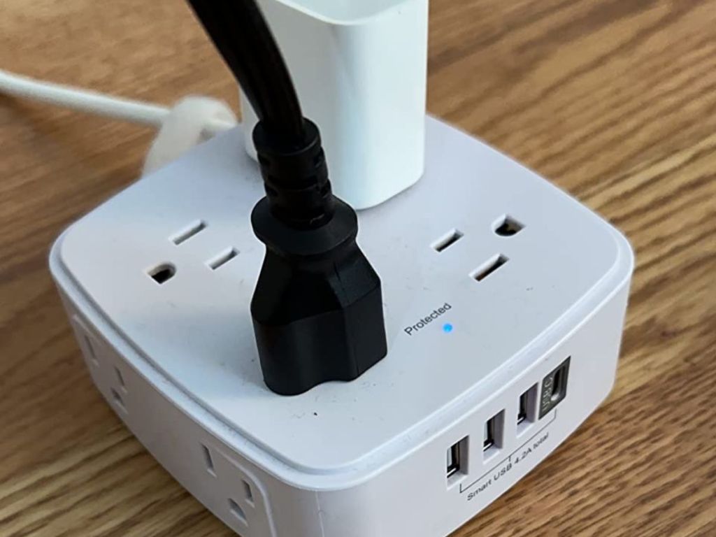 A Yishu Surge Protector with two plugs plugged into it