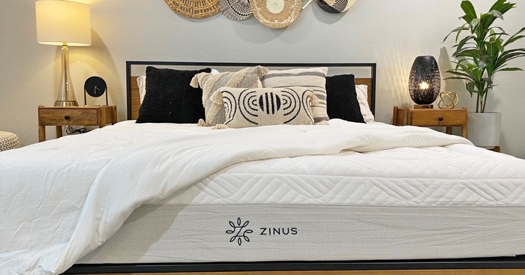 bedding pulled back on bed to show zinus brand
