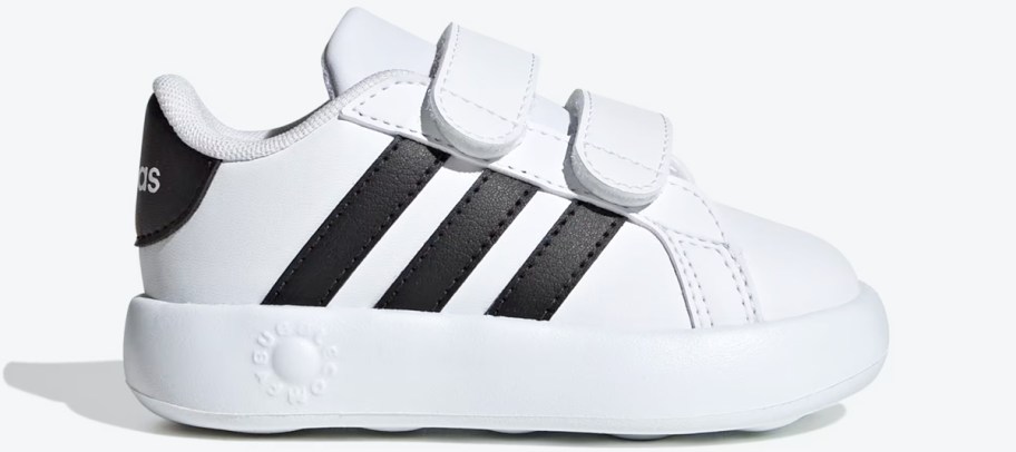 white sneaker with 3 black stripes and velcro straps