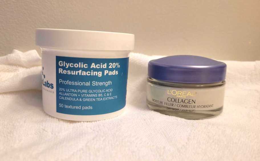 resurfacing pads in tub and loreal moisturizer in containers on white towel