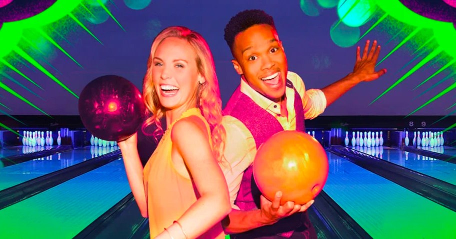 woman and man holding bowling balls in bowling alley