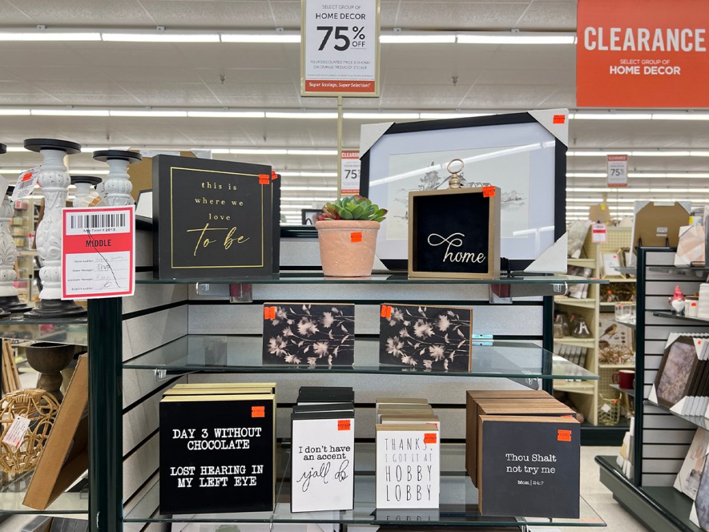 wooden decor signs on shelf at hobby lobby